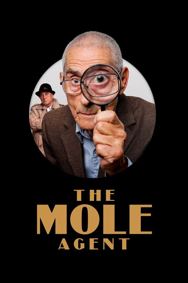 An elderly man looks through a magnifying glass inside a circle, with another person watching him in the background. The rest of the poster is black.