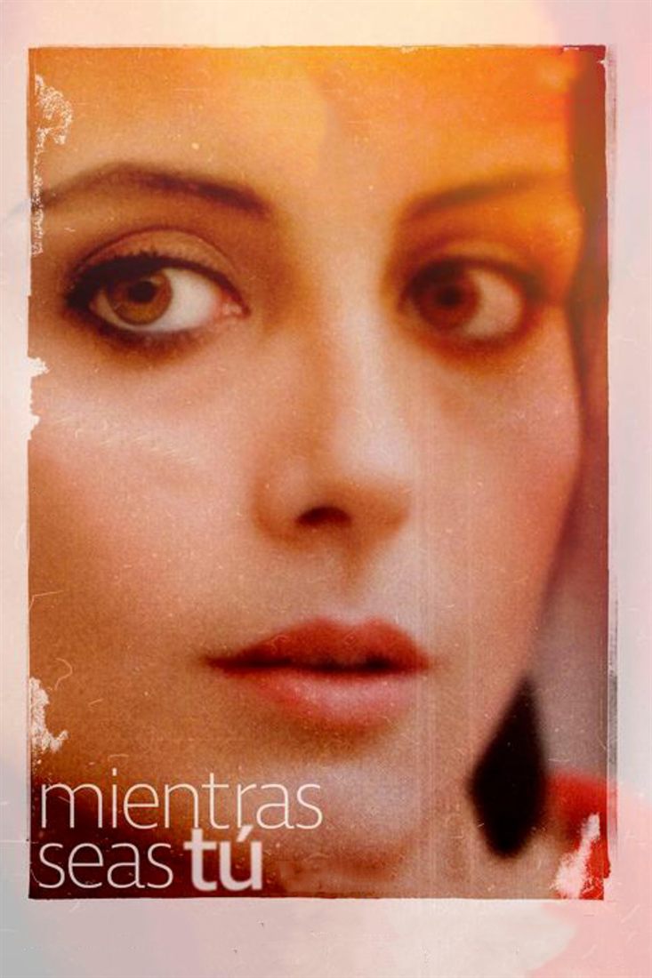 Close-up of the actress Carme Elias's face as a young woman, in warm light.